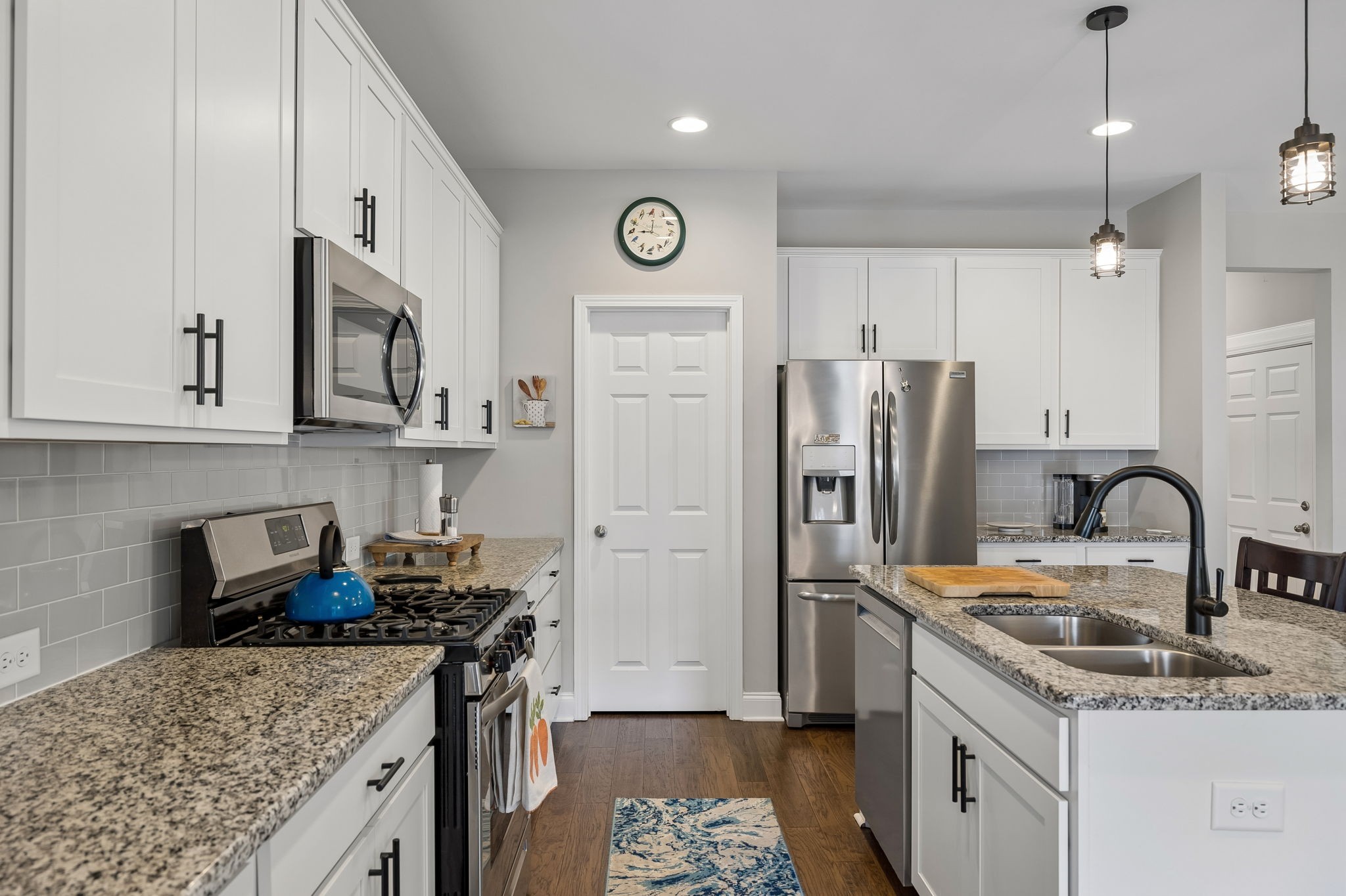 1017 Violet Street Spring Hill, TN 37174 - Photo 11 of 36 a kitchen with stainless steel appliances granite countertop a sink stove and refrigerator