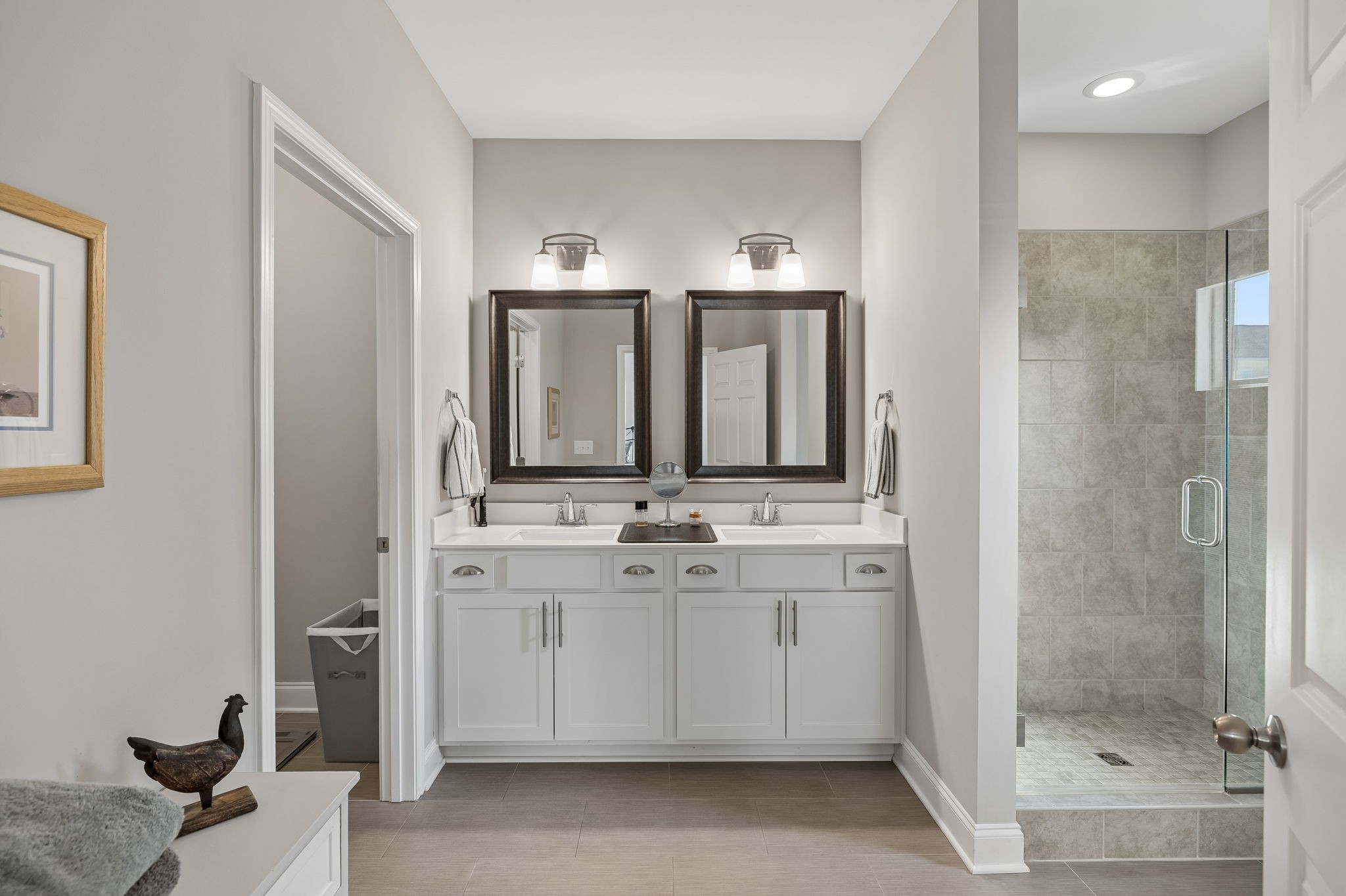 1017 Violet Street Spring Hill, TN 37174 - Photo 15 of 36 a bathroom with a double vanity sink mirror and shower