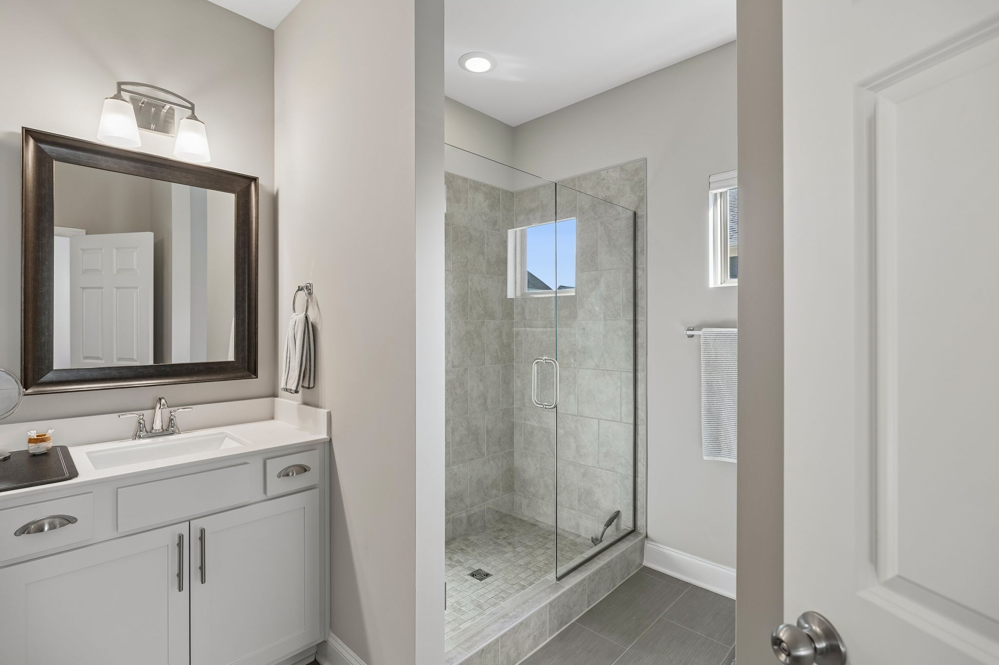 1017 Violet Street Spring Hill, TN 37174 - Photo 16 of 36 a bathroom with a shower sink and mirror
