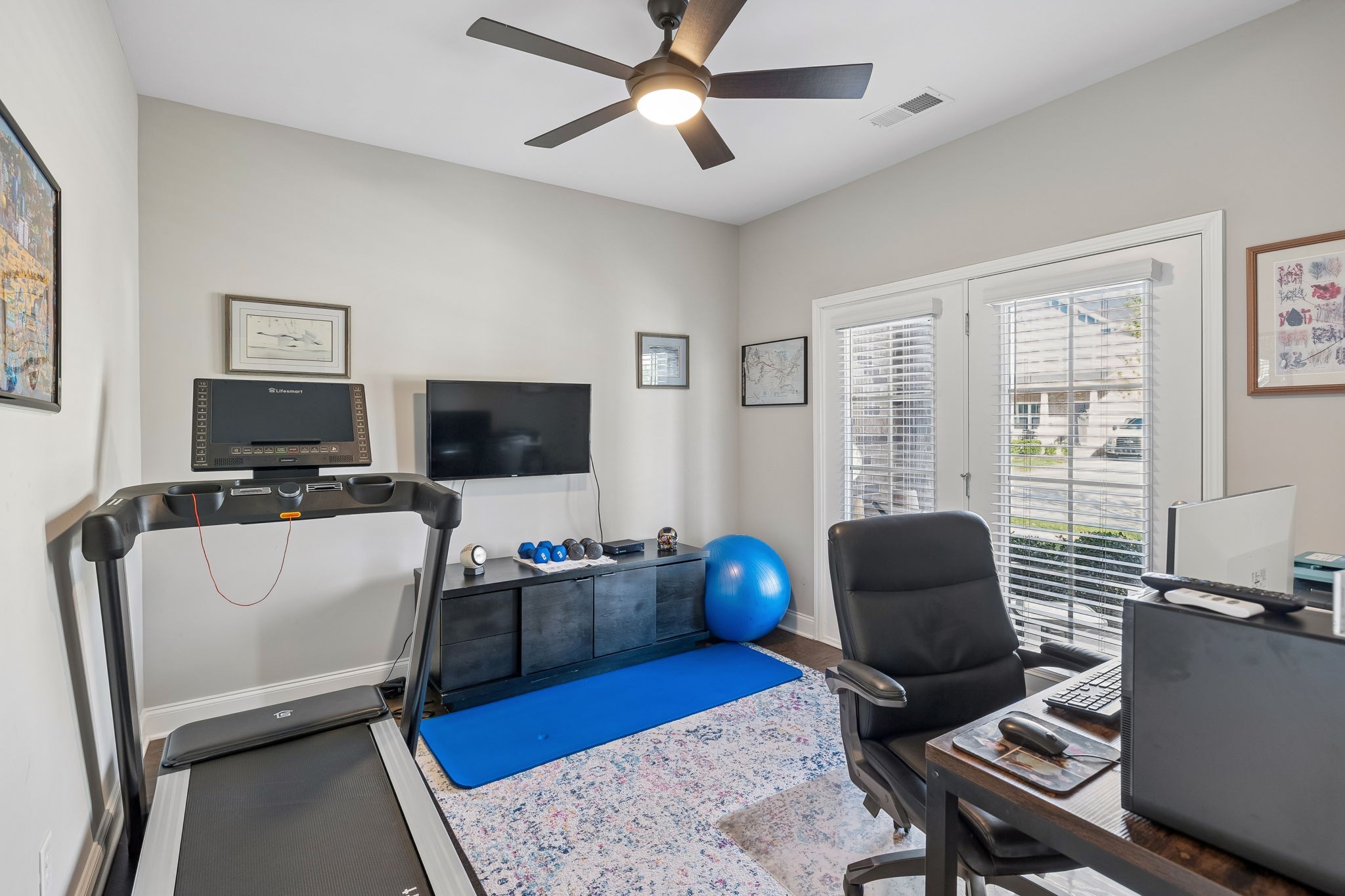1017 Violet Street Spring Hill, TN 37174 - Photo 18 of 36 a living room with furniture a flat screen tv and a window