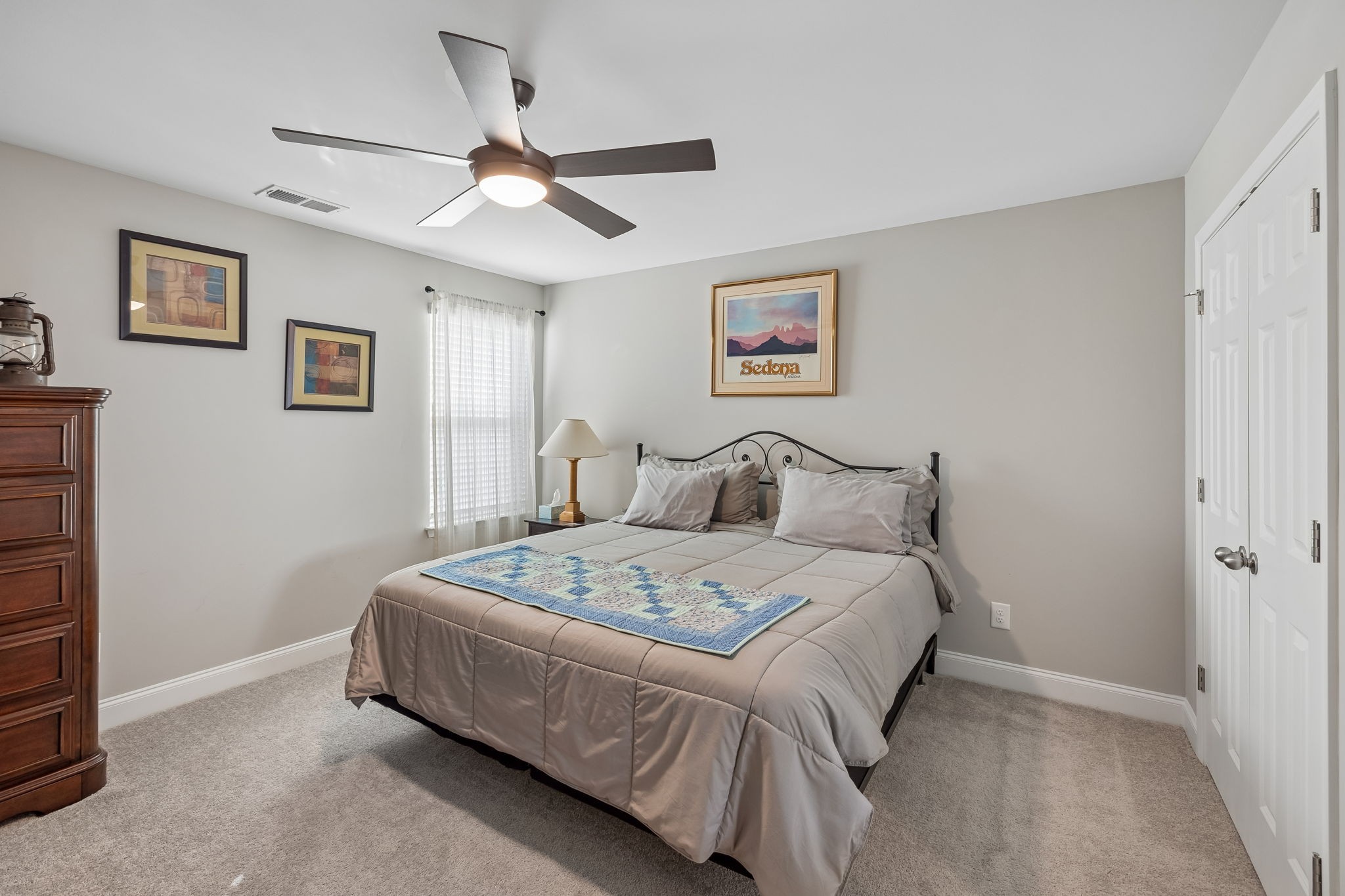 1017 Violet Street Spring Hill, TN 37174 - Photo 24 of 36 a bedroom with a bed and a wall painting