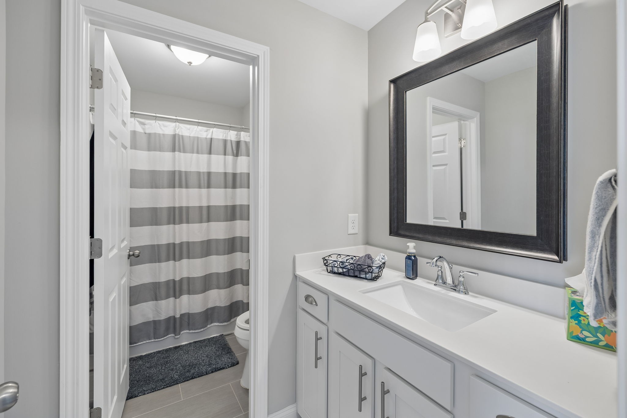 1017 Violet Street Spring Hill, TN 37174 - Photo 26 of 36 a bathroom with a sink and a mirror