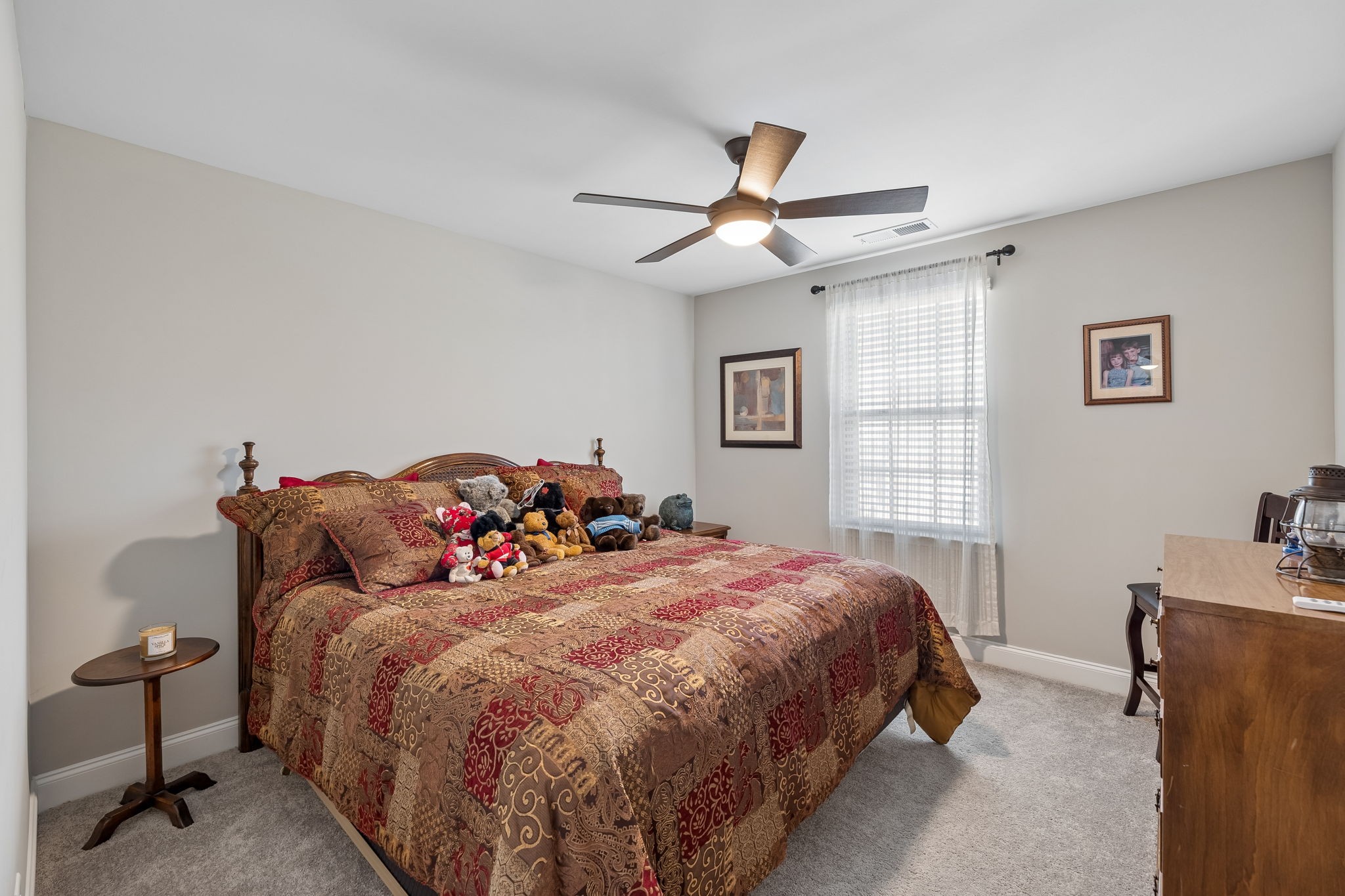 1017 Violet Street Spring Hill, TN 37174 - Photo 27 of 36 a bedroom with a bed and a chandelier fan