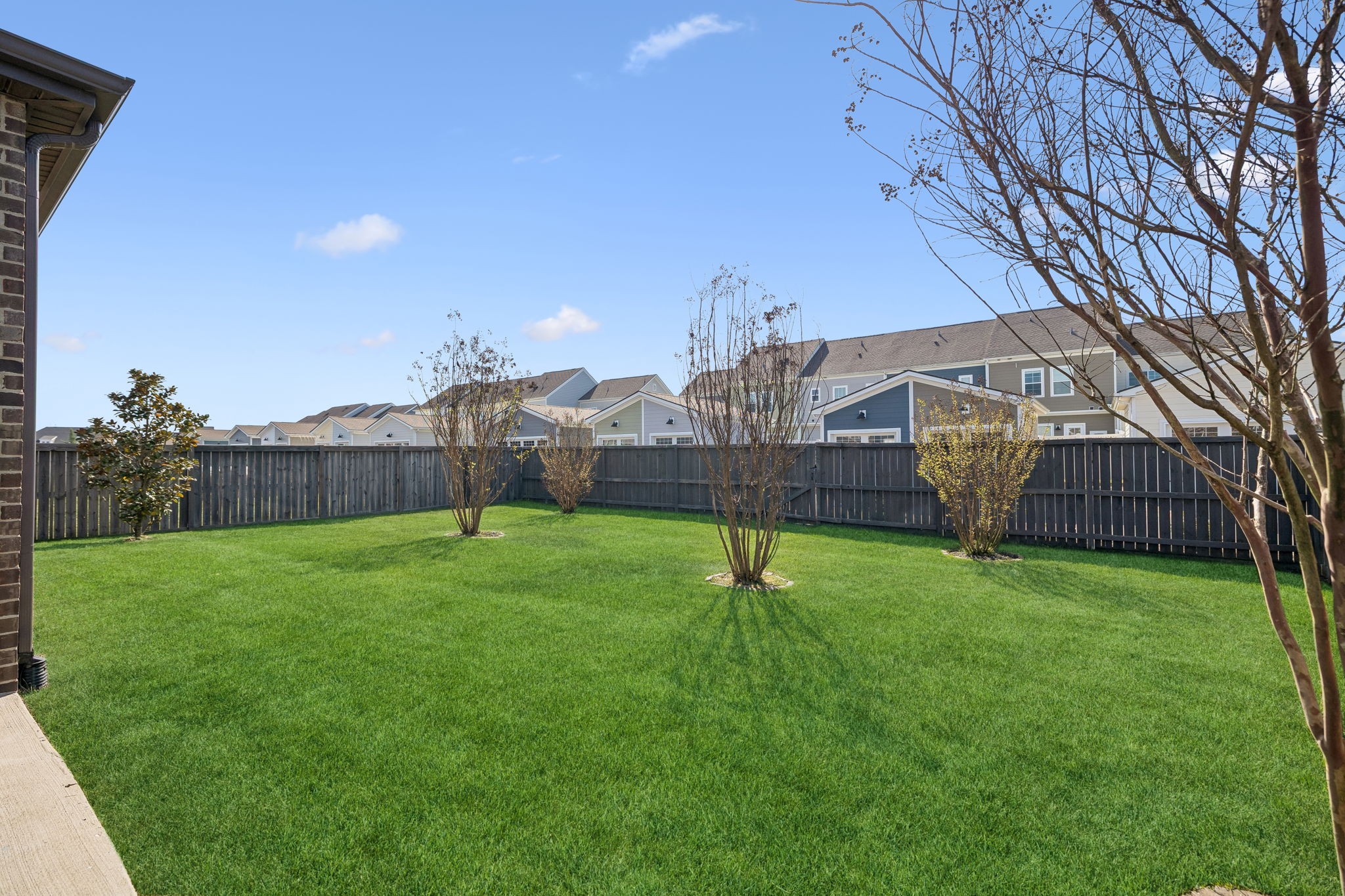 1017 Violet Street Spring Hill, TN 37174 - Photo 30 of 36 a view of a backyard with a garden and deck