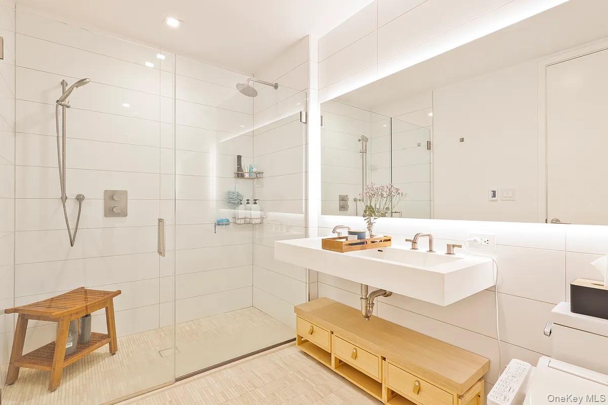 98 Front Street, Unit 9J Brooklyn, NY 11201 - Photo 7 of 10 Bathroom with a shower stall and toilet