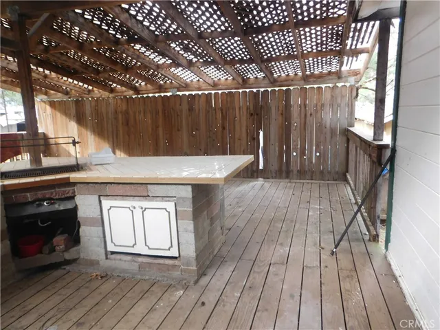 a view of a house with a yard and large trees