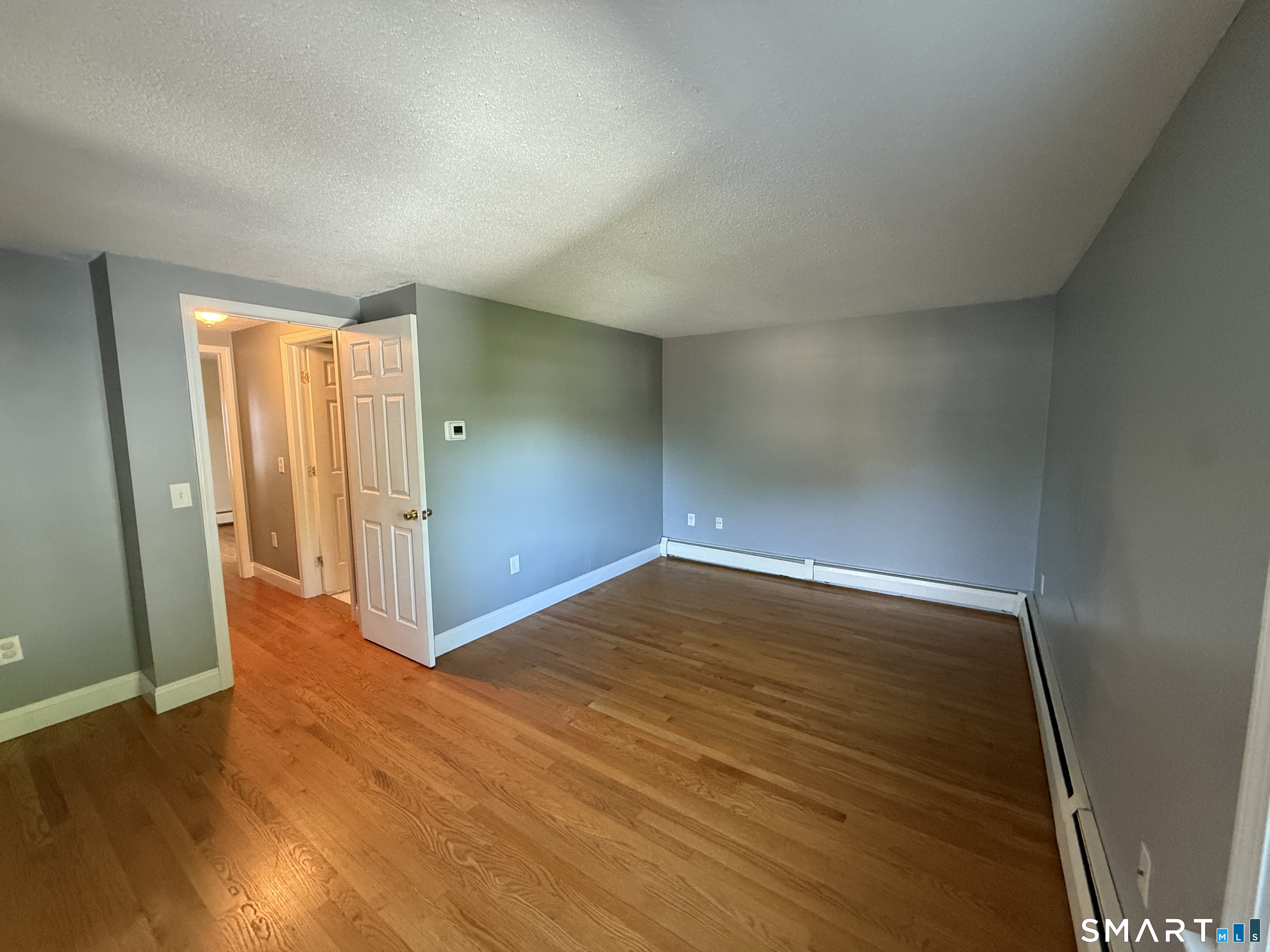 808 East Main Street Torrington, CT 06790 - Photo 33 of 40 an empty room with wooden floor and windows
