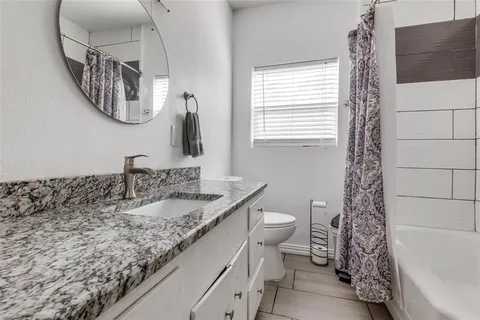a bathroom with a sink a toilet and a shower