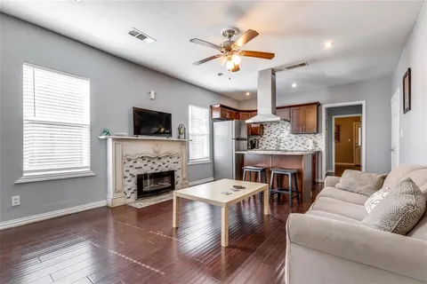 a living room with furniture a fireplace and a flat screen tv