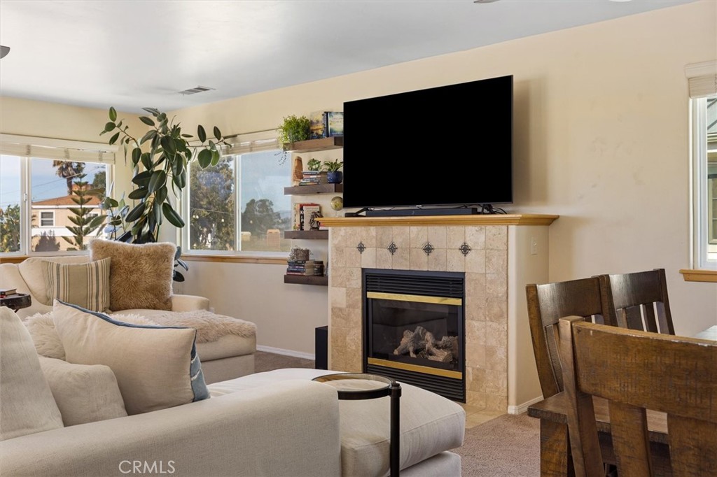 1187 Main Street Morro Bay, CA 93442 - Photo 6 of 33 a living room with furniture a flat screen tv and a fireplace