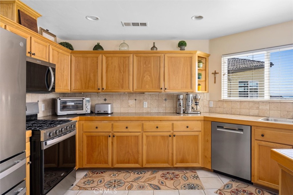 1187 Main Street Morro Bay, CA 93442 - Photo 9 of 33 a kitchen with stainless steel appliances granite countertop a sink stove and cabinets