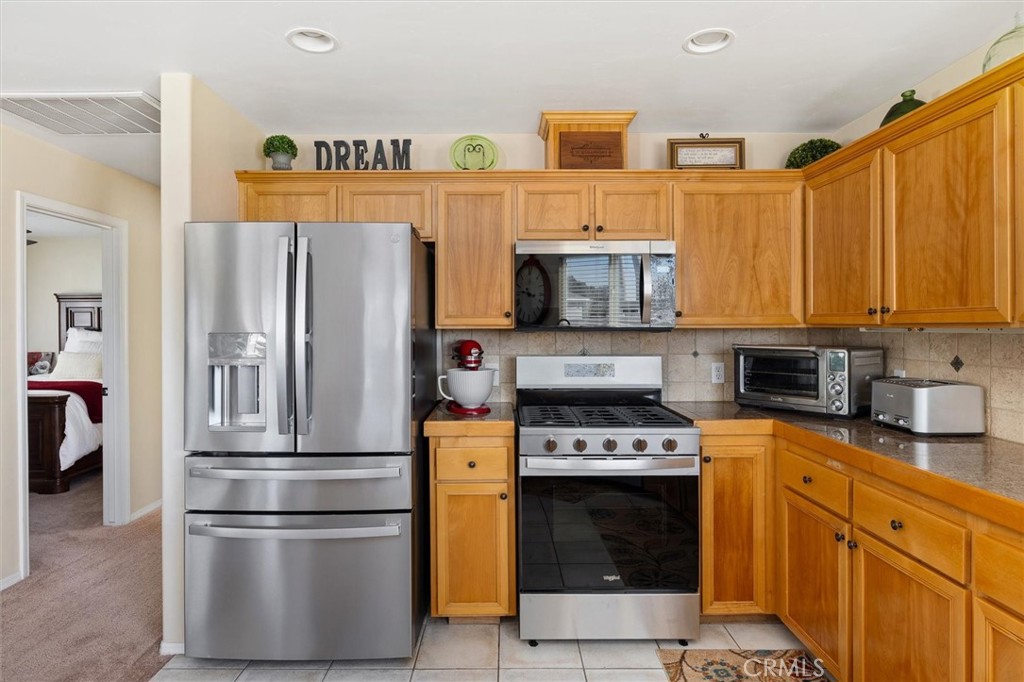 1187 Main Street Morro Bay, CA 93442 - Photo 10 of 33 a kitchen with stainless steel appliances granite countertop a refrigerator stove and microwave