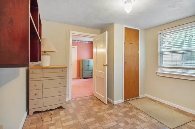 a view of a room with a window and a ceiling fan