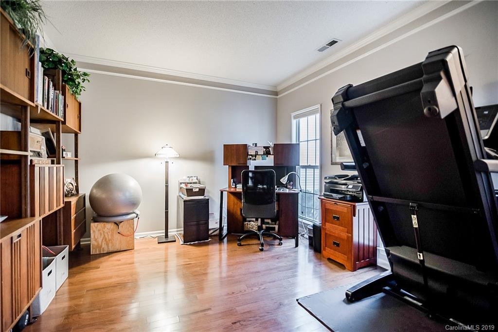 144 Comata Road Mooresville, NC 28117 - Photo 18 of 35 a room with wooden floor and gym equipment