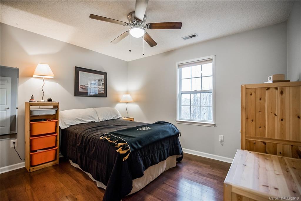 144 Comata Road Mooresville, NC 28117 - Photo 24 of 35 a bedroom with a bed and wooden floor