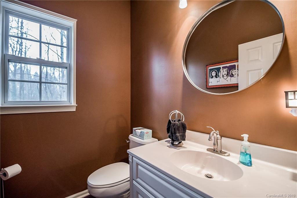 144 Comata Road Mooresville, NC 28117 - Photo 29 of 35 a bathroom with a toilet sink vanity and mirror
