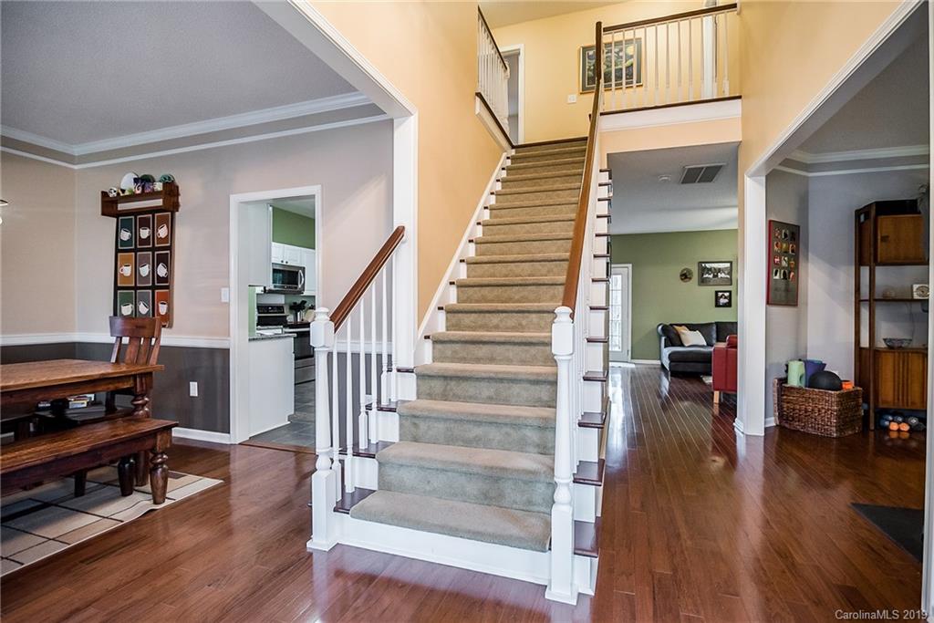 144 Comata Road Mooresville, NC 28117 - Photo 4 of 35 a view of a livingroom with wooden floor and stairs