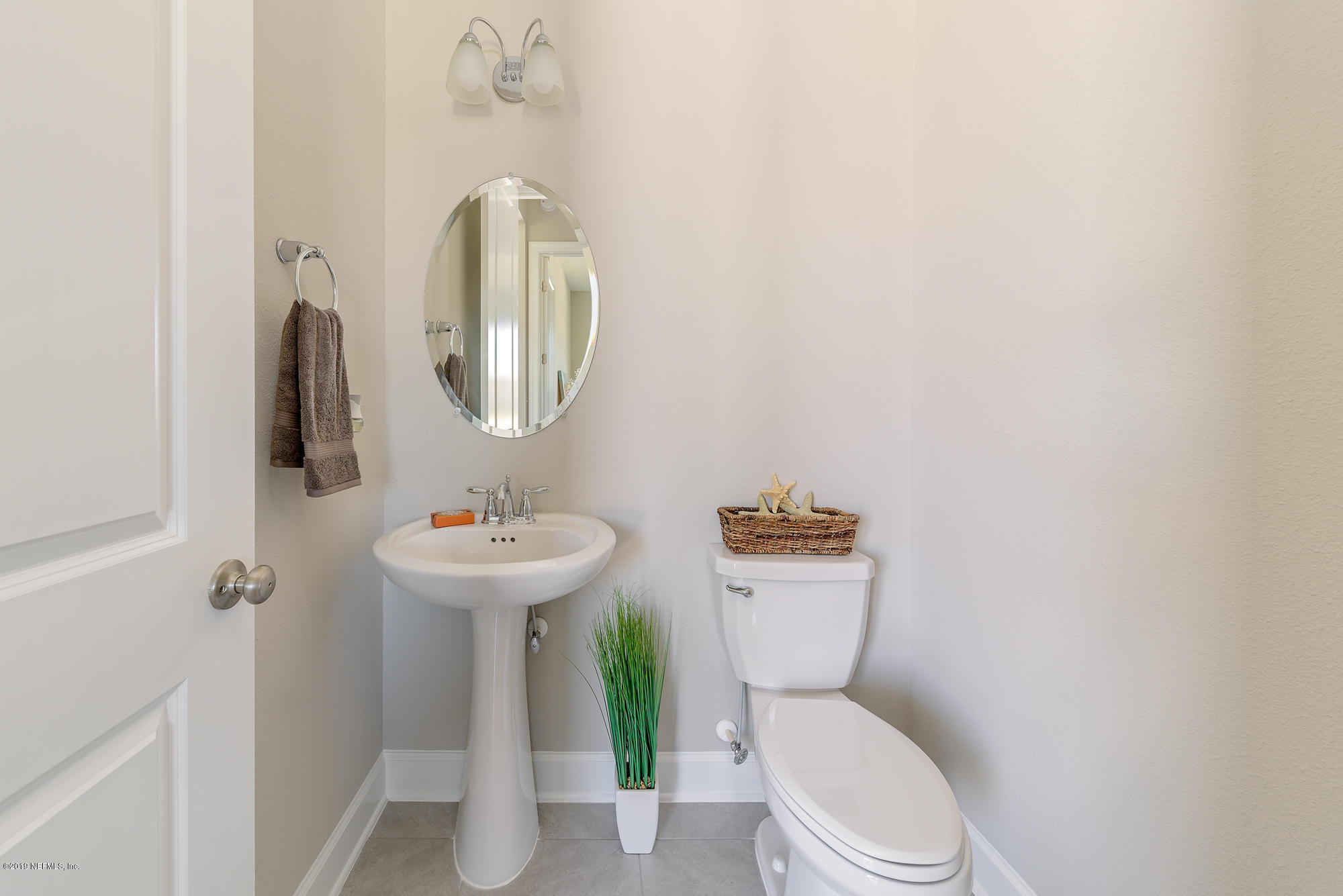 71 Lansing Court St. Augustine, FL 32092 - Photo 11 of 49 a white toilet sitting next to a bathroom sink