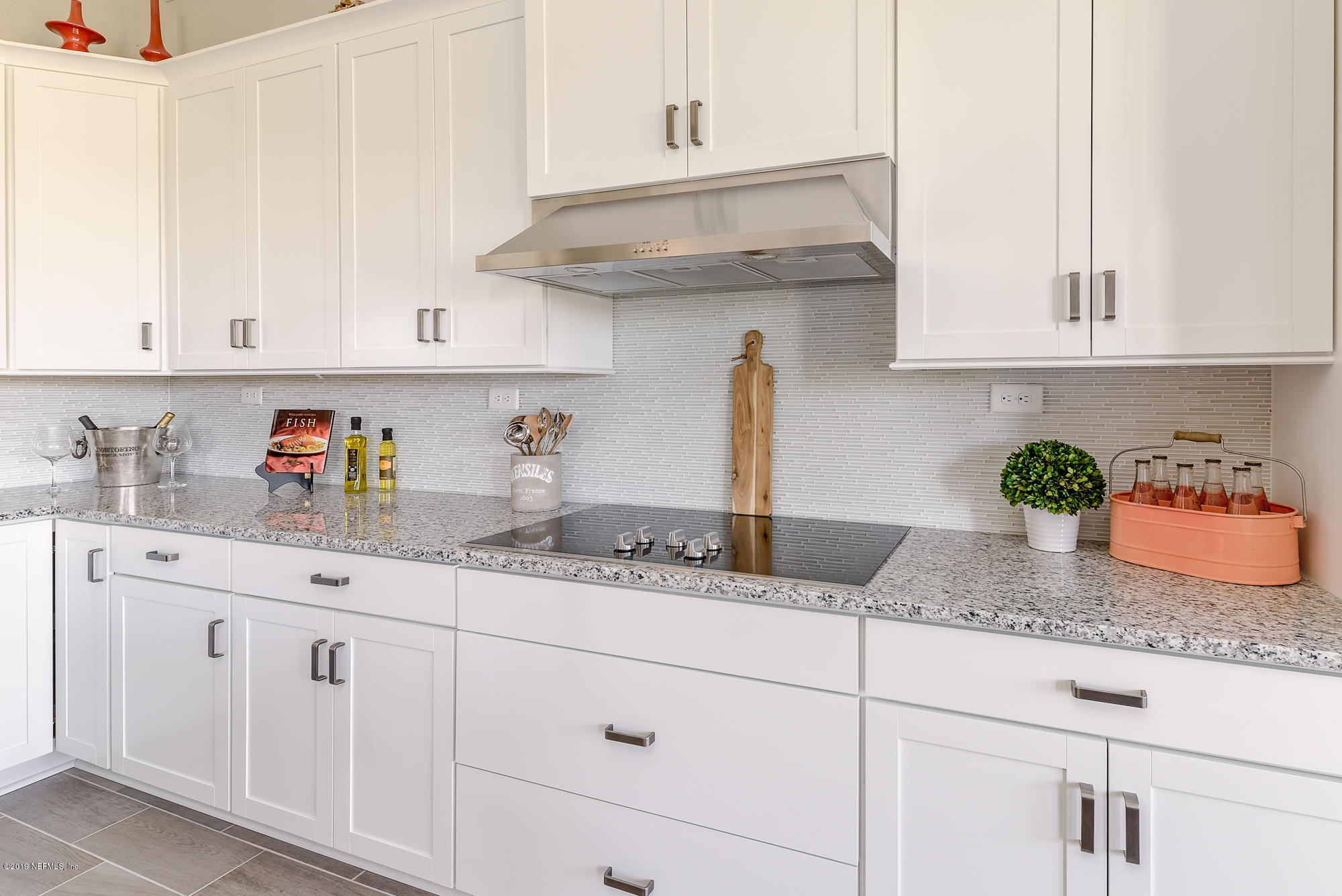 71 Lansing Court St. Augustine, FL 32092 - Photo 19 of 49 a kitchen with white cabinets and a granite counter tops
