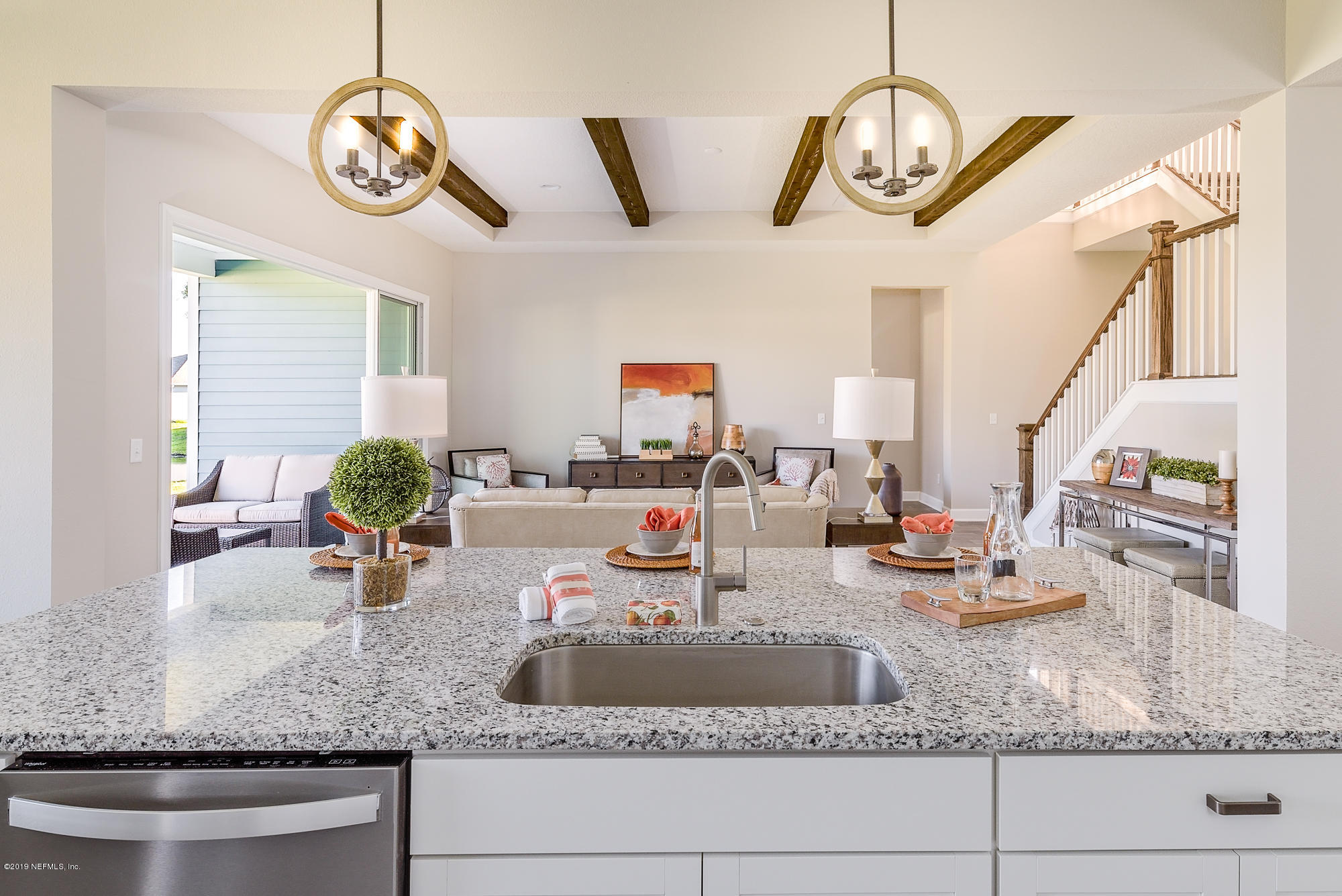 71 Lansing Court St. Augustine, FL 32092 - Photo 20 of 49 a view of a kitchen with granite countertop a couch and chandelier