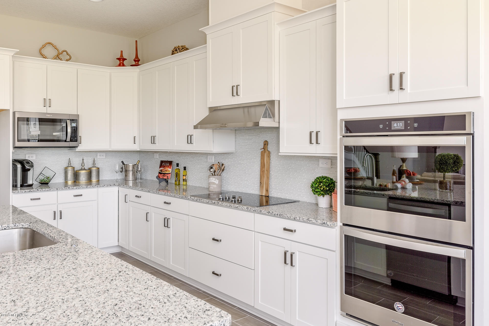 71 Lansing Court St. Augustine, FL 32092 - Photo 22 of 49 a kitchen with granite countertop white cabinets and white appliances