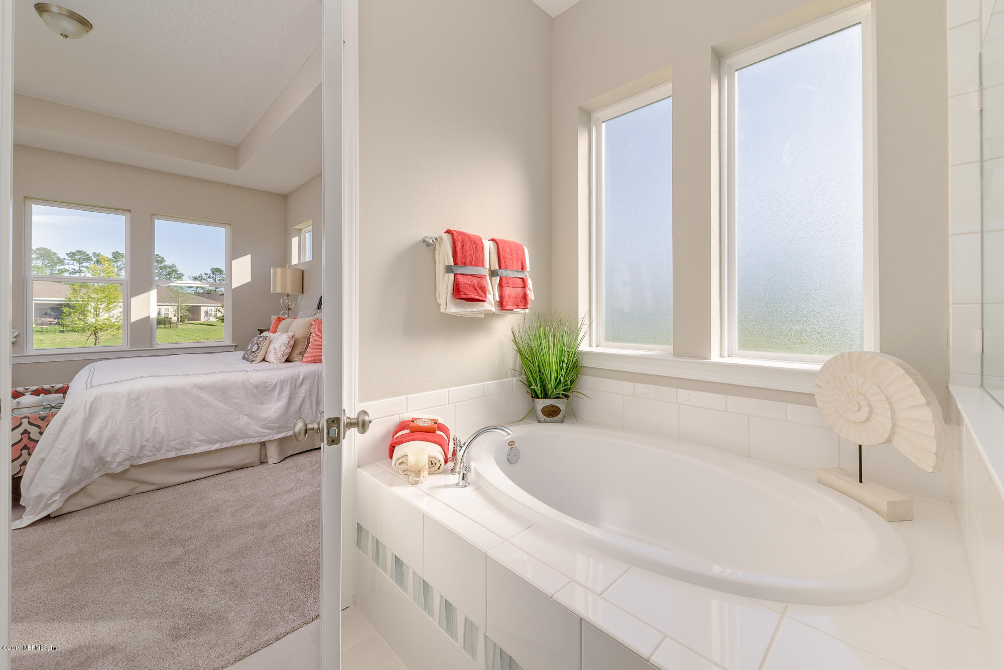 71 Lansing Court St. Augustine, FL 32092 - Photo 31 of 49 a bathroom with a tub sink and a window