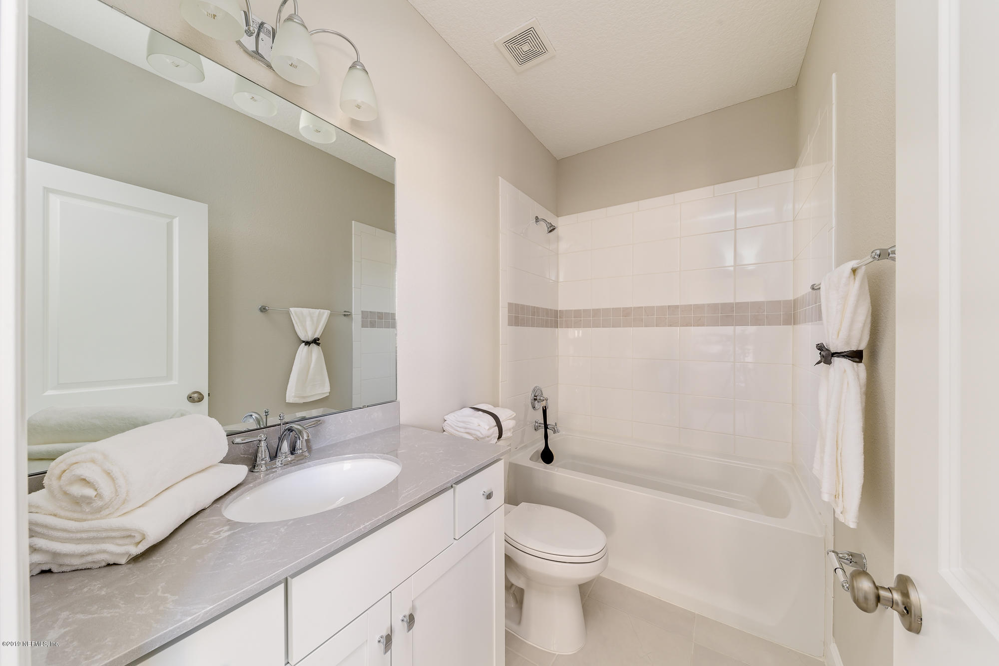 71 Lansing Court St. Augustine, FL 32092 - Photo 42 of 49 a bathroom with a granite countertop sink mirror vanity and toilet