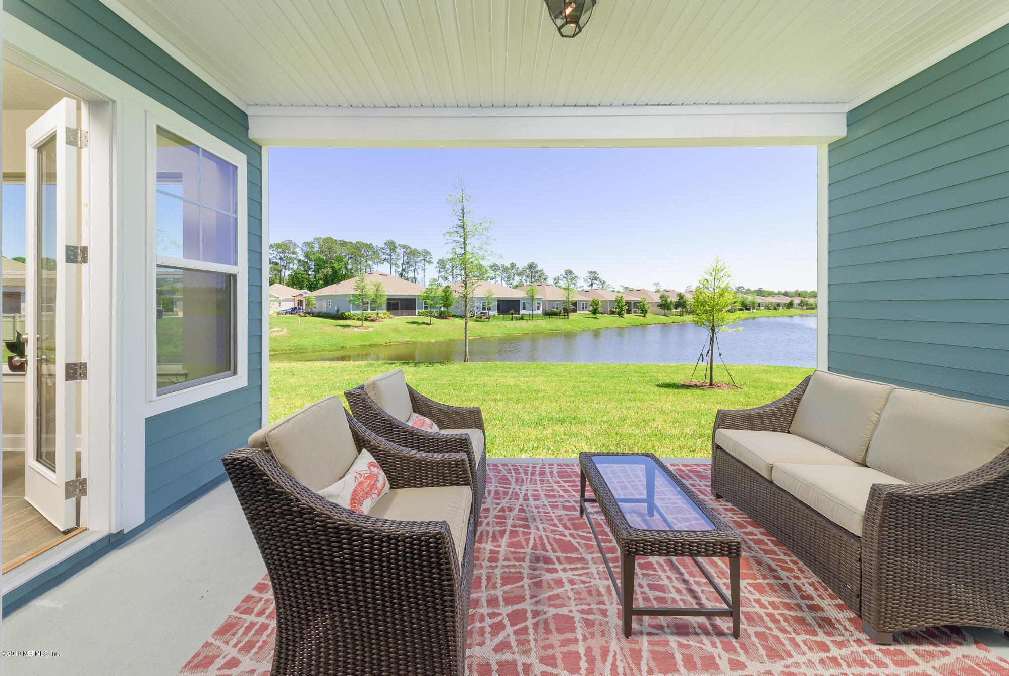 71 Lansing Court St. Augustine, FL 32092 - Photo 46 of 49 a view of chairs and table in patio with a yard