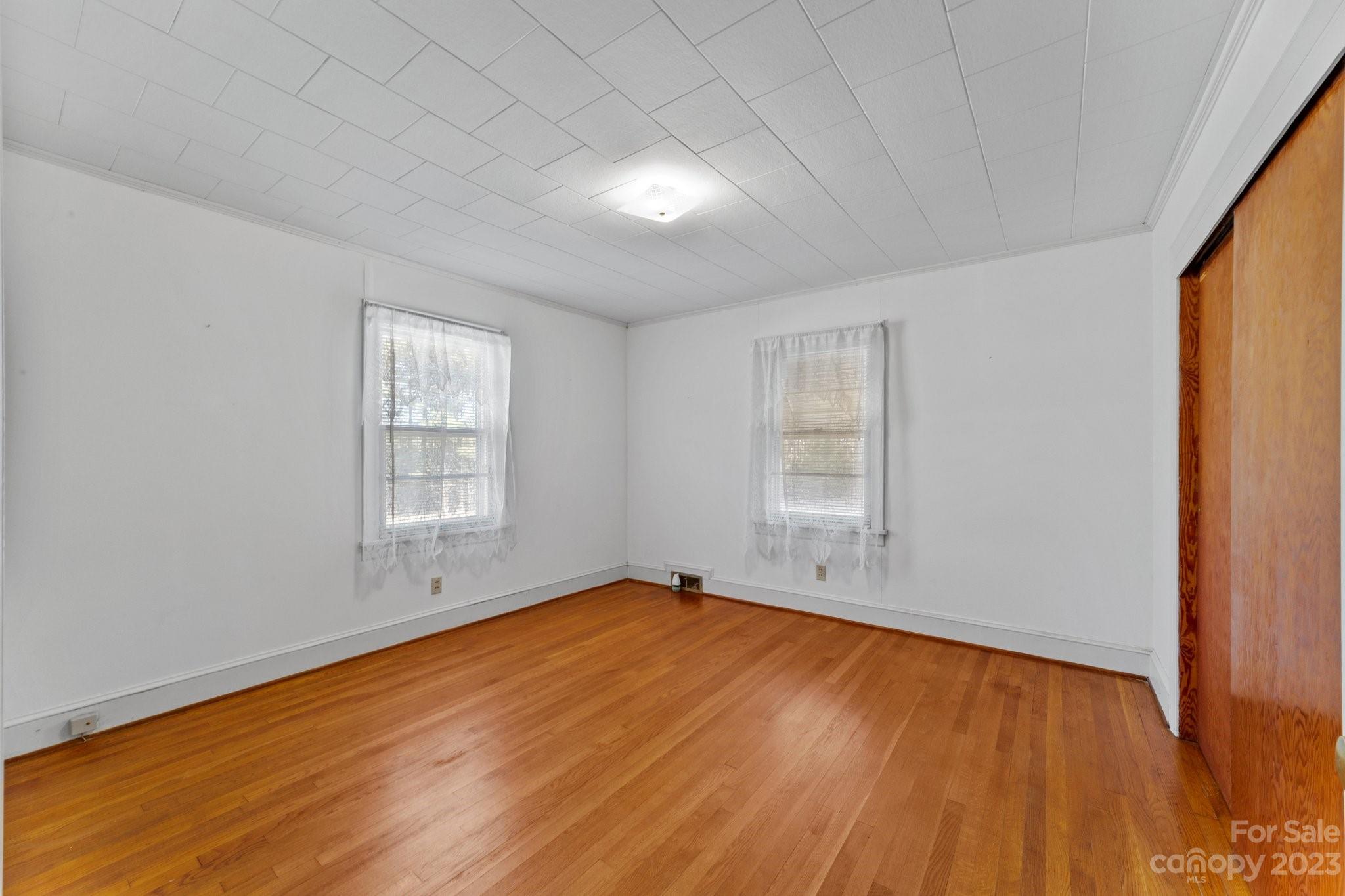 820 Thompson Road Salisbury, NC 28147 - Photo 21 of 48 an empty room with wooden floor and windows