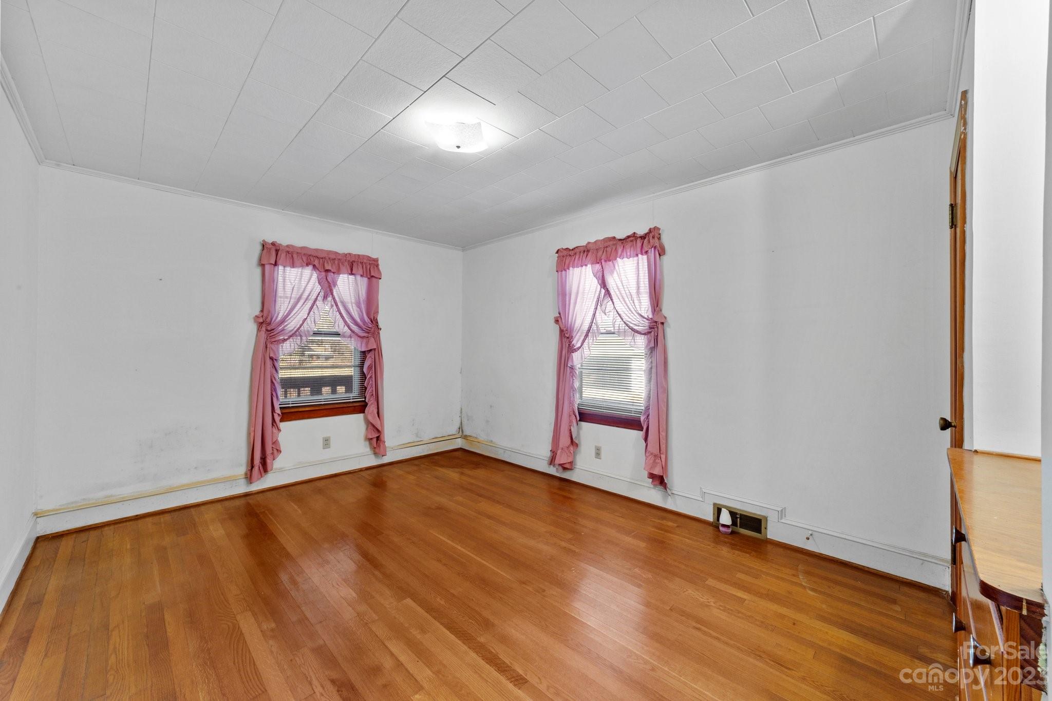 820 Thompson Road Salisbury, NC 28147 - Photo 22 of 48 a view of an empty room with window and hardwood floor