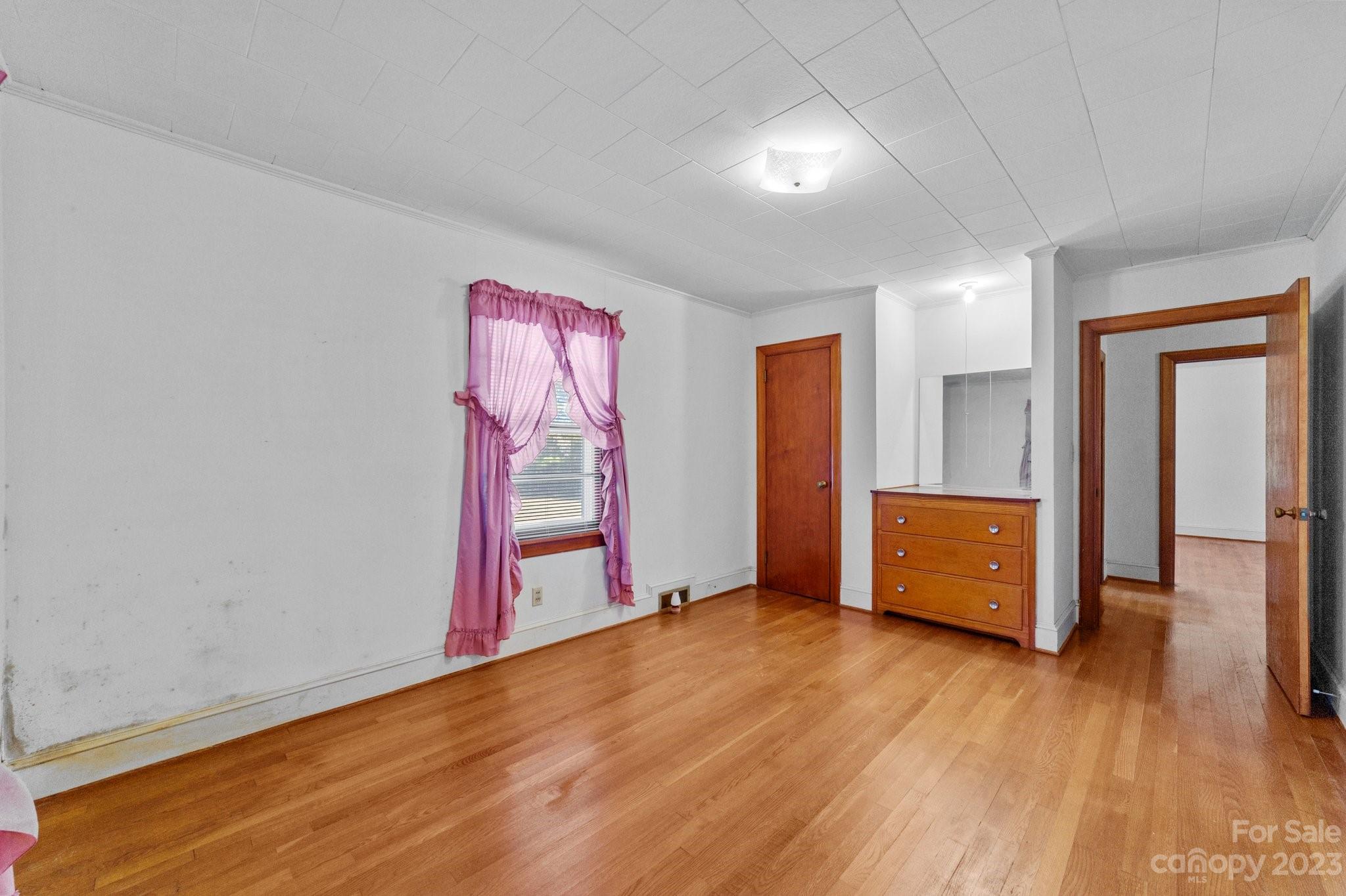 820 Thompson Road Salisbury, NC 28147 - Photo 23 of 48 an empty room with wooden floor and windows