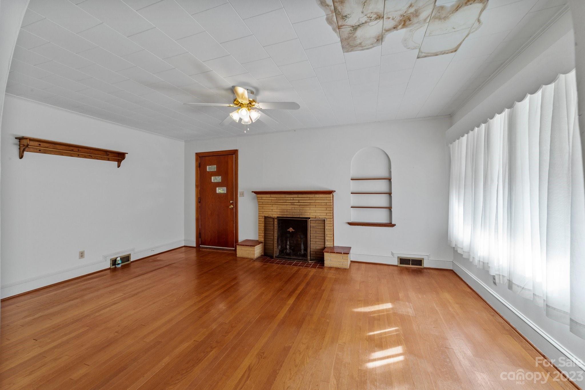 820 Thompson Road Salisbury, NC 28147 - Photo 9 of 48 an empty room with windows and fireplace