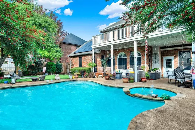 a chairs and table in the patio with a garden
