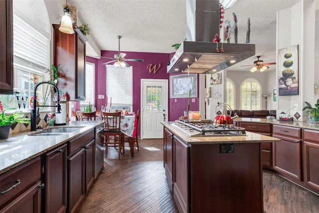 a kitchen with stainless steel appliances wooden cabinets a sink and a window