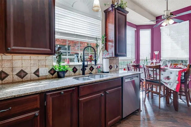 a kitchen that has a stove and a wooden floor