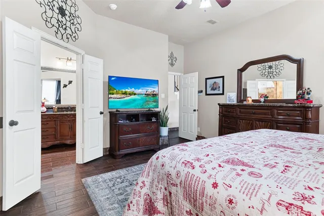 a bedroom with a bed and a flat screen tv