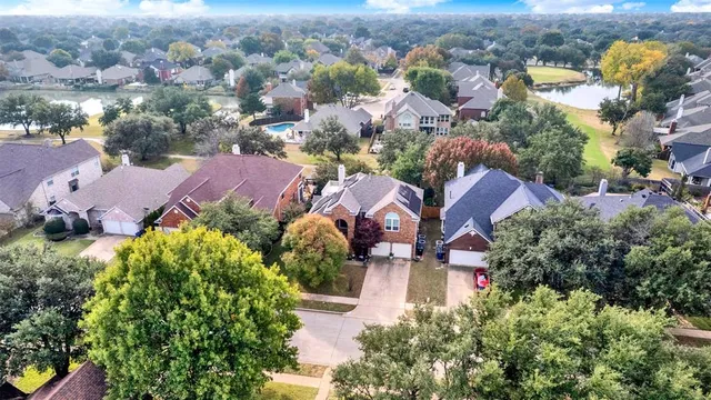 an aerial view of multiple houses with yard