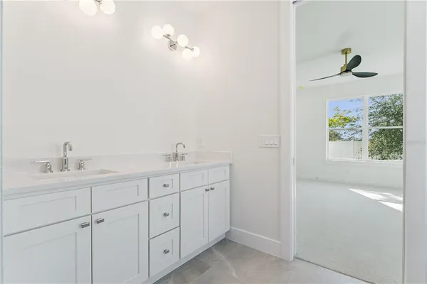 a bathroom with a double vanity sink and mirror