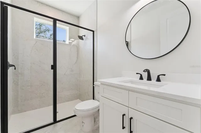 a bathroom with a sink a toilet and a mirror