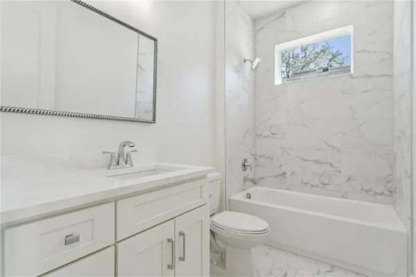 a bathroom with a sink a toilet and a bathtub