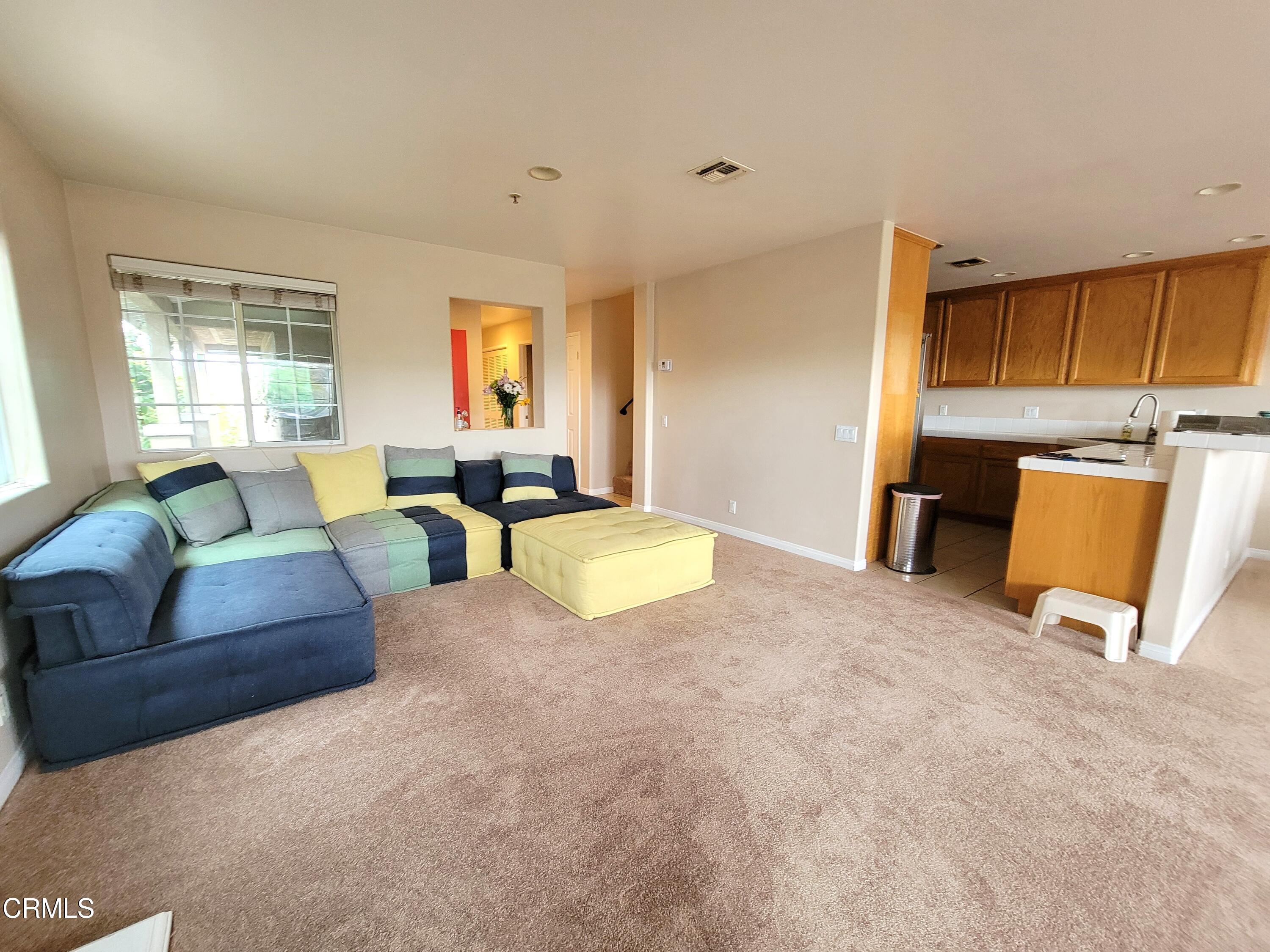 811 Dunes Street Oxnard, CA 93035 - Photo 3 of 10 a living room with furniture a window and kitchen view