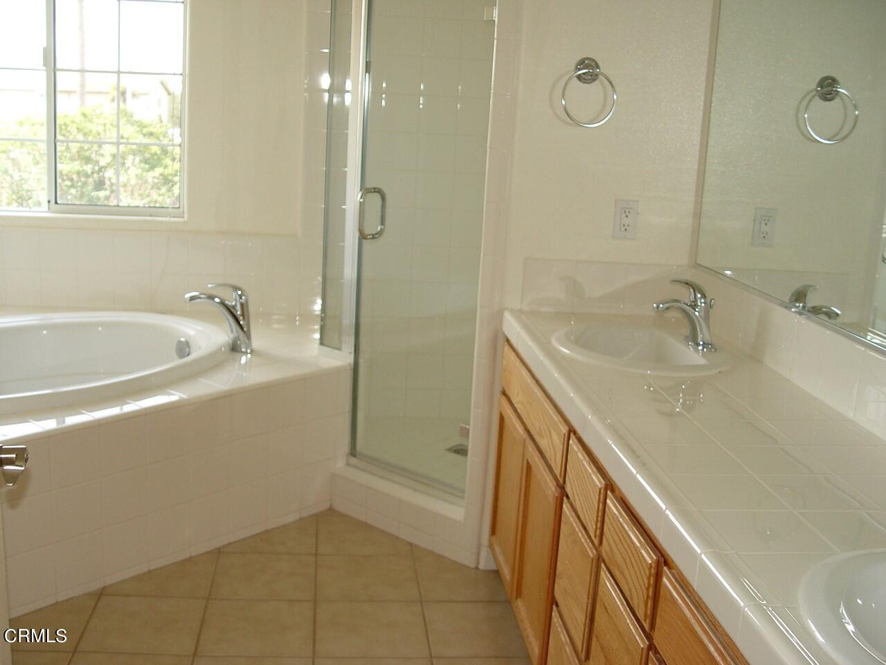 811 Dunes Street Oxnard, CA 93035 - Photo 5 of 10 a bathroom with a tub sink and mirror