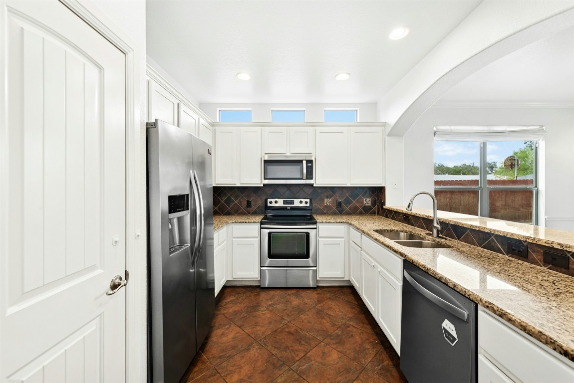 430 Old Fitzhugh Road, Unit 2 Dripping Springs, TX 78620 - Photo 12 of 28 a kitchen with a sink stove and refrigerator