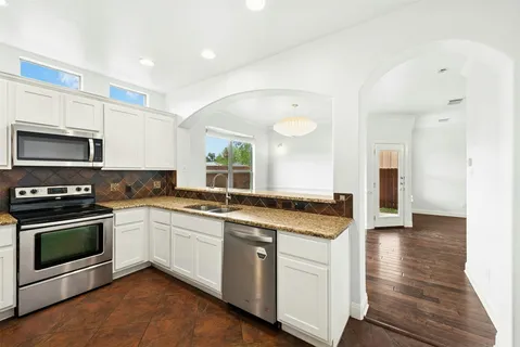 a kitchen with stainless steel appliances granite countertop a stove and a sink