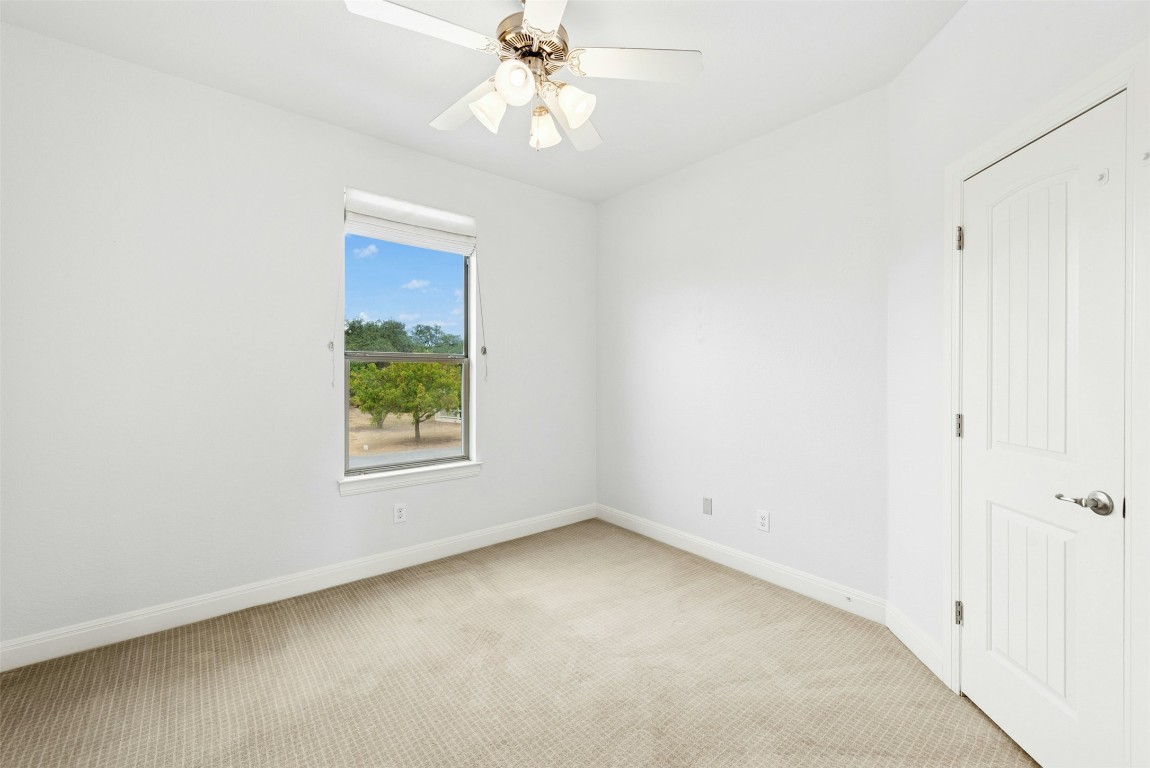 430 Old Fitzhugh Road, Unit 2 Dripping Springs, TX 78620 - Photo 16 of 28 an empty room with a window and a fan