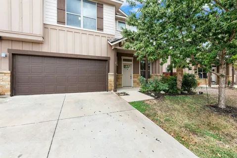 a front view of a house with garage