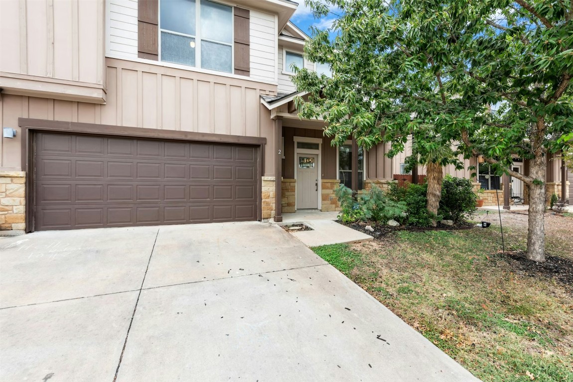 430 Old Fitzhugh Road, Unit 2 Dripping Springs, TX 78620 - Photo 2 of 28 a front view of a house with garage