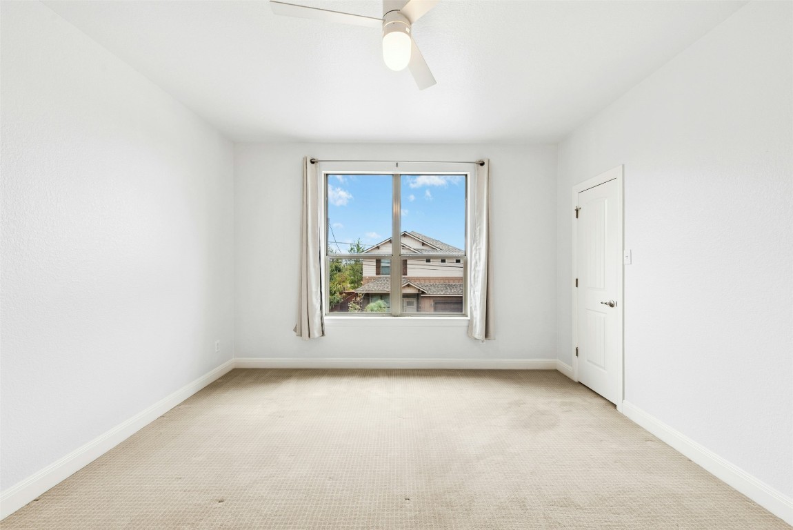 430 Old Fitzhugh Road, Unit 2 Dripping Springs, TX 78620 - Photo 23 of 28 an empty room with a window