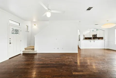 a view of a kitchen with wooden floor and a sink