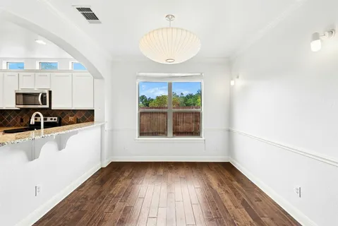 a view of a room with wooden floor and a window